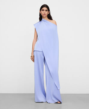 Peplum top with asymmetric overlaid cape
