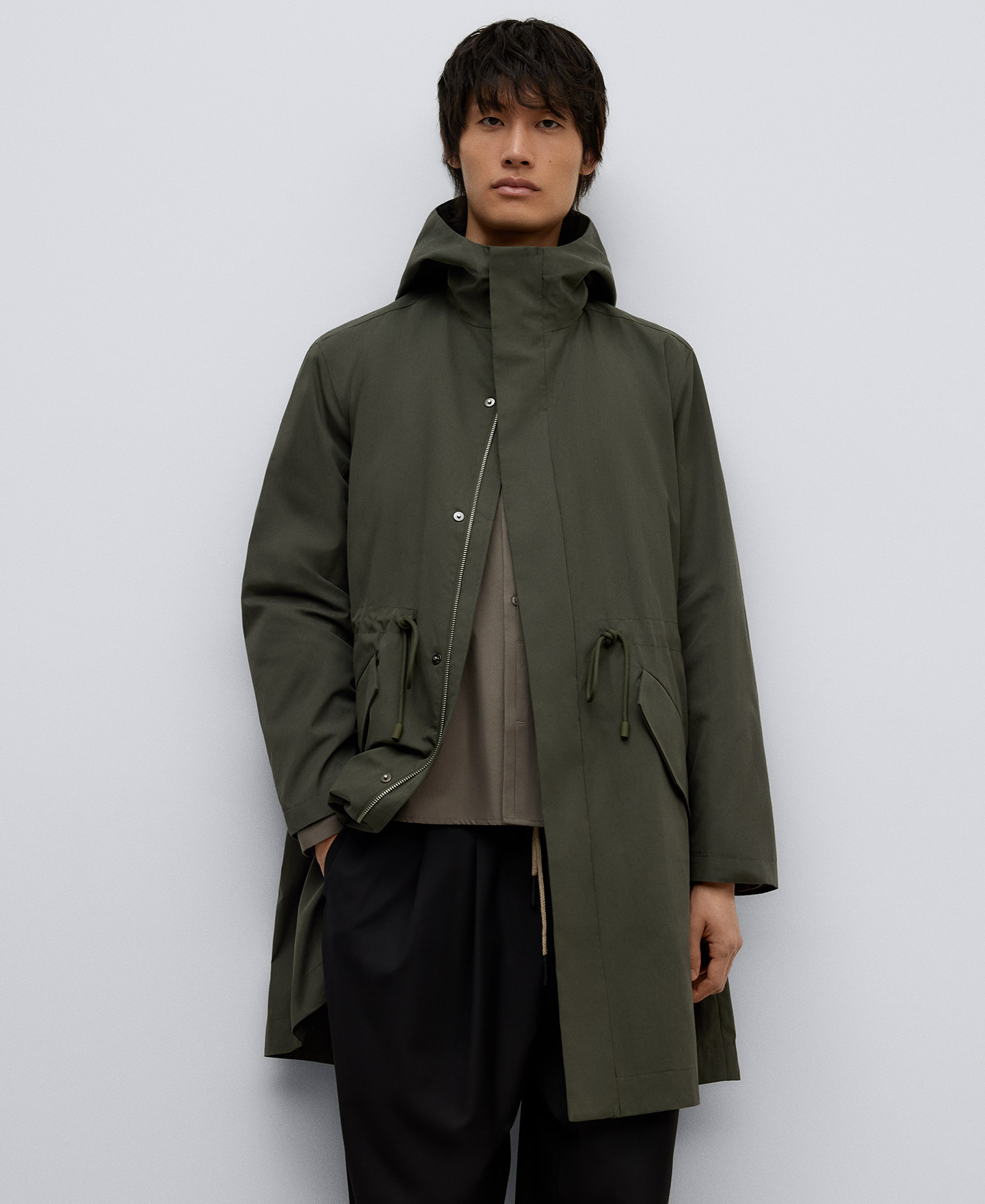 Green hooded trench man image number 0